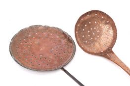 A copper hanging skimmer: with engraved floral foliate decoration and handle with hooked end,