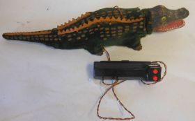 Marx, a battery operated crocodile with celluloid head, plush covered metal body with rubber fins,