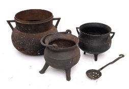An iron twin-handled cauldron: of traditional bag shape, 27cm across,