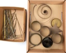 A box of approximately 50 small brass rods: along with four French clock movement case cylinders.