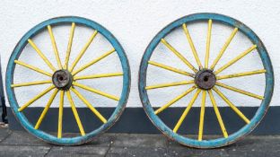 A pair of cartwheels: of fifteen spoke pattern with steel banded rims, 140 diameter.