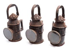 Three early 20th century railway hand signal lanterns,