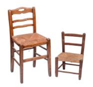 An ash ladderback chair: with rush seat, on square legs with stretchers,
