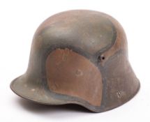 A WWI period German M1916 Stahlhelm:, hand painted camouflage finish with brown leather liner,