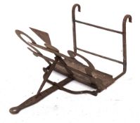 A Scottish iron bar-grate toaster: with thistle motif centre and shaped handle, 37cm wide.