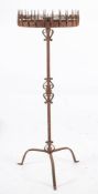 A late 19th/early 20th century wrought iron pricket stand: the central sconce with a circular