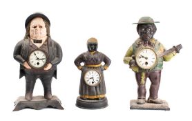Three reproduction cast iron novelty 'moving eye' clocks in the form of a politition,
