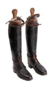 A pair of brown officer boots the type worn by officers in the household cavalry, with wooden trees.