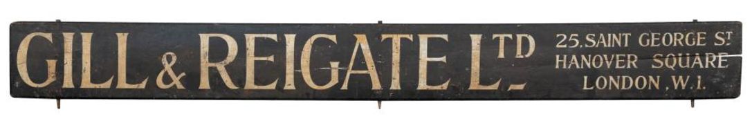 An early 20th century wooden tram advertising hoarding 'Gill & Reigate Ltd 25,