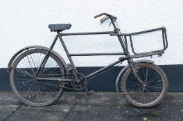 A delivery bicycle: with pannier front and double crossbar frame.