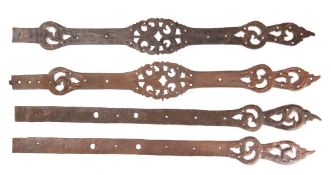 Two pairs of steel straps, possibly 16th century: with pierced scrollwork decoration,