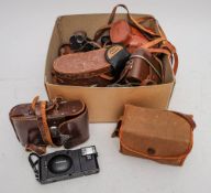 A collection of various cameras and binoculars: various formats including an Olympus XA 2 camera