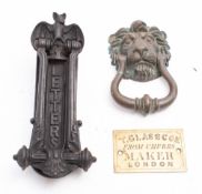 A brass lion's mask door knocker:,