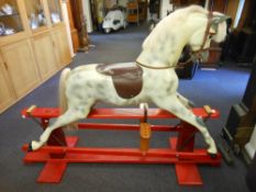 A painted grey and dappled fibreglass rocking horse by Haddon's: with white horsehair mane and tail,