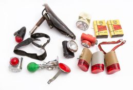 A group of various bicycle lamps and accessories: including s Wrights's black leather saddle.