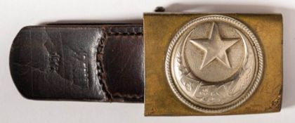 A WWI Turkish Enlisted ranks belt buckle: in brass and nickel silver with leather strap stamped 'J