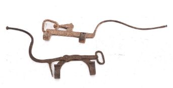 Two wrought iron kettle tilts: of plough pattern, 18th Century.