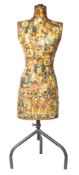 An early 20th century decoupage decorated mannequin.
