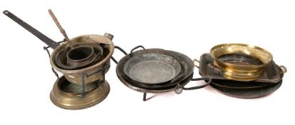 Eight various copper, brass and tinned shallow pans:, a brass saucepan with iron handle,