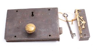 A 19th century iron and brass rim lock: with brass knob to side and brass fretwork to keep, 27.