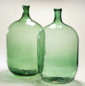 Two green glass carboys: 54cm high.