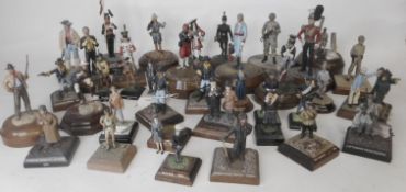 A collection of painted white metal and painted figures and vignettes in various scales from 1/35th