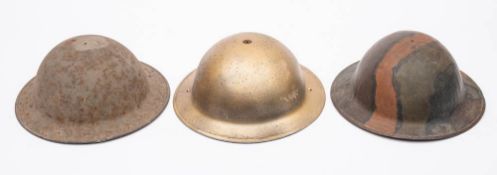Two WWII period Mk I steel helmets and a MK III steel helmet by Briggs Motor Bodies: (3) (no