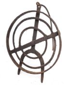 A circular wrought iron revolving grid iron: with scrollwork designs and tripod feet, 31cm diameter,