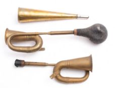 Two reproduction brass car horns and one other horn: (3)