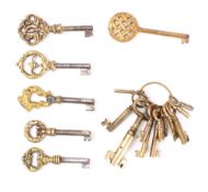 Five steel keys with decorative brass bows: together with a collection of eleven various brass keys