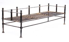 A 19th Century black enamelled steel kitchen fender: with railed shelf for warming pots or kettles,