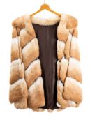 A lady's half length fur coat.