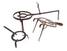 A wrought iron circular adjustable trivet:, 22cm diameter, 64cm long,