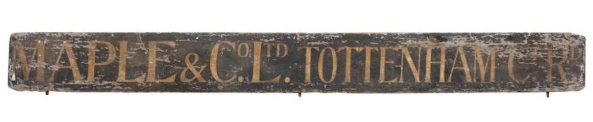 An early 20th century wooden tram advertising hoarding for 'Maple & Co Ltd Tottenham Ct Rd';