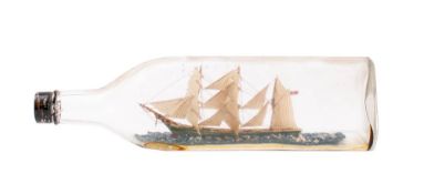 A clipper ship in a bottle: set full sails over deck with green hull to waterline base, 29.