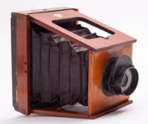 A mahogany and brass 'The XIT' three quarter plate strut camera by Shew,