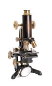 An early 20th century black lacquer laboratory microscope by G Baker, London: No. 6281.
