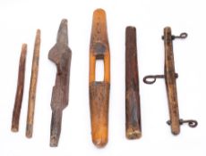 A wood yoke:, 90cm long, another with adapted hook, together with four wood and iron animal hangers.