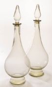 Two large clear glass swan neck apothecary carboys: with baluster stoppers ,