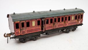 A Carette O gauge maroon passenger coach '132 D 35': grey roof over litho printed body marked 'GC