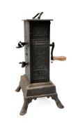 A 19th Century Continental clockwork spit engine: in blackened tin and metal oblong casing,