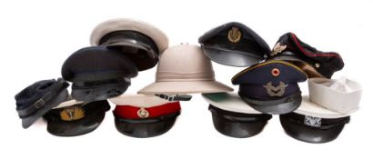 A collection of various peaked caps, including RAF and RN,