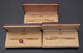 A Cross 2805 gold plated roller ball pen and two 2802 gold plated ball pens,