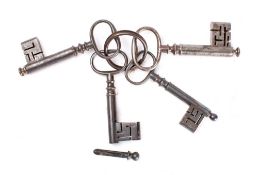 Four 18th century English steel keys with dust caps (spigots): 10.5 to 11.