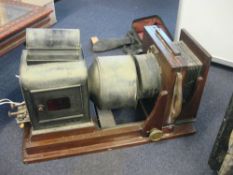An early 20th century Hunter Penrose mahogany and brass magic lantern: with fitted Ross 7 1/4 inch