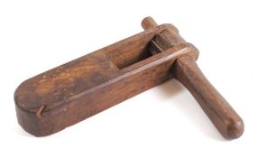 A 19th Century oak rattle: with turned handle.