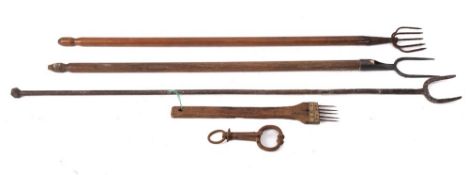 A wrought iron twin tine long handled toasting fork:, a twin tine fork with wood turned handle,