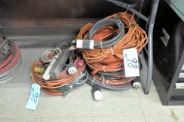 Lot-Extension Cords, Power Strips, Etc. in (2) Stacks on Floor Under (1) Table