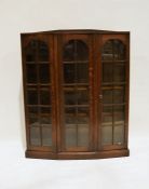 Early 20th century oak display cupboard with breakfront, astragal-glazed doors to the shelves, on