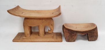 African carved wood stool, the hollowed rectangular top supported by model of an elephant and an